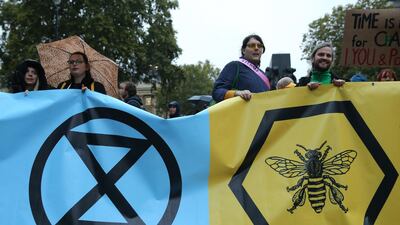 Climate change activists from the Extinction Rebellion block the road with a banner that calls on the government to act now to reduce greenhouse gas emissions to halt biodiversity loss and suggests the creation of citizen's assemblies on Whitehall outside Downing Street in central London, on October 7, 2019 during the group's global climate protests. AFP / ISABEL INFANTES