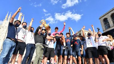 Ineos Grenadiers rider Egan Bernal poses with the trophy and teammates. Reuters