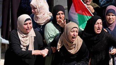 The sisters of Sufian al-Khawaja, killed by Israeli forces near a Jewish settlement in the West Bank village of Nilin in 2020, mourn during his funeral in Ramallah on March 18, 2023 after his body was returned for burial a day earlier. AFP