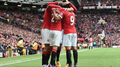 Manchester United’s Ander Herrera, left, celebrates with teammates after scoring the opening goal against Arsenal. Paul Ellis / AFP