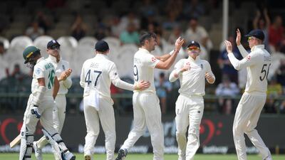 England bowler James Anderson, cente, is congratulated by teammates after taking the wicket of Kashev Maharaj. Getty