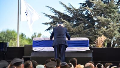 Israeli president Reuven Rivlin touches the coffin of former president and prime minister Shimon Peres during his funeral on September 30, 2016, at Jerusalem’s Mount Herzl national cemetery. Nicholas Kamm / Agence France-Presse