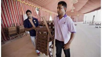 Employees at the Sheraton Abu Dhabi Hotel and Resort near the mina prepare a tent that will be hosting Ramadan festivities.