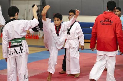 Boys train during a Taekwondo class held at Asem bin Thabit Secondary School for Boys in Fujairah. Pawan Singh / The National