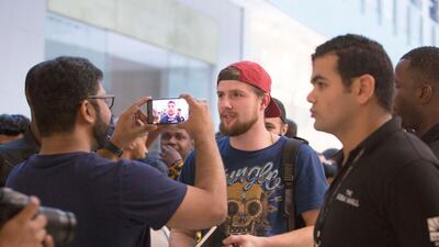 Vladislav Mikheev, in the red cap, flew in from Russia. He was the first to get his new iPhone XS. Leslie Pableo / The National