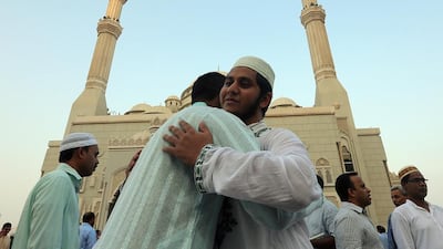 People greet each other after Eid prayers at the Al Noor Mosque in Sharjah in 2016. Satish Kumar / The National