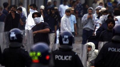 Youths armed with petrol bombs confront police during rioting in Bradford, 200 miles (320 km) north of London, on the night of July 7, 2001. Reuters