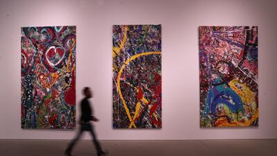 British artist Sacha Jafri walks past his artwork "The Journey of Humanity" at Dubai's Leila Heller Gallery. The painting was created over seven months as the world's largest canvas, then broken down into 70 separate pieces. Getty Images