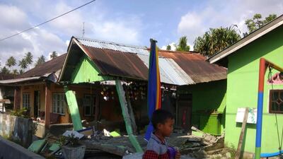 A house sits damaged after a magnitude 6.1 earthquake in Donggala, central Sulawesi, Indonesia. Disaster Management Agency via AP