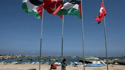 A Palestinian boy looks at the Turkish and Palestinian flags fluttering at the site of a monument (unseen) built to commemorate the first anniversary of the death of nine Turks, who were shot dead last May when Israeli naval commandos seized a Turkish ship that was part of a flotilla trying to break the Gaza blockade. Mahmud Hams / AFP Photo