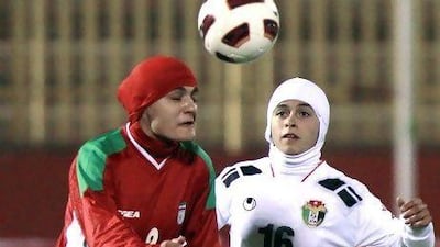 Shehnaz Jebreen, right, of the Jordan women's football team battles with Azar Mousaui of Iran for the ball. Prince Ali of Jordan, a member of Fifa's executive board, is pushing for the ban on wearing hijabs to be dropped.