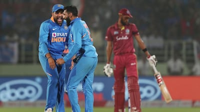 India's Rohit Sharma and Ravindra Jadeja, centre, celebrate the dismissal of Roston Chase during the second ODI in Visakhapatnam on Wednesday. AFP