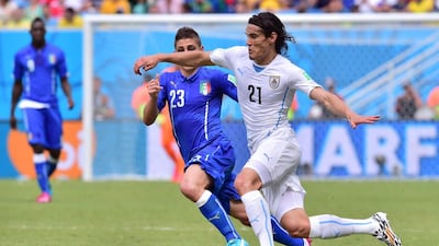 Uruguay midfielder Edinson Cavani, right, moves past Italy midfielder Marco Verratti during their 2014 World Cup Group D match at the Dunas Arena in Natal on June 24, 2014. Giuseppe Cacace / AFP