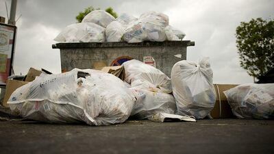 A dumpster at Marina Mall in Abu Dhabi overflows with rubbish.