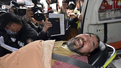 A suspect, identified by police as 55-year-old Kim Ki-jong, is carried on a stretcher off an ambulance as he arrives at a hospital in Seoul on March 5. US Ambassador Mark Lippert was in stable condition after the man screaming demands for a unified North and South Korea slashed him on the face and wrist with a knife. AP