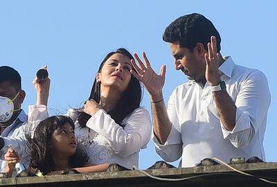 Bollywood actors Abhishek Bachchan and Aishwarya Rai Bachchan, along with their daughter Aaradhya, clap from atop a residential building to thank essential service providers during a one-day curfew imposed in Mumbai. AFP