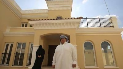 Rehab Sayed Ahmed, seen here with her son Yosef Salem, now lives comfortably in a five-bedroom villa with her seven-member family. Ravindranath K / The National