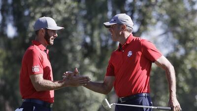 USA’s Dustin Johnson and Matt Kuchar celebrate after winning their match 5 & 4 during morning foursomes at the Ryder Cup. Chris Carlson / AP Photo