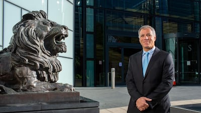 Georges Elhedery, Co-CEO of Global Banking and Markets at HSBC, beside one of the bronze lions in Canary Wharf, London, that guard the entrance to the bank's global headquarters. Mark Chilvers for The National