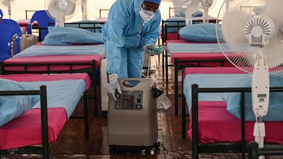 A health worker arranges an oxygen concentrator machine at a newly inaugurated Covid-19 centre in Chennai, India. AFP