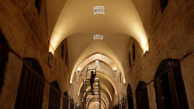 In this photo, a Syrian worker works on the newly renovated al-Saqatiyah Market in the old city of Aleppo, Syria. AP