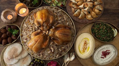 Chicken majboos, centre, surrounded by traditional mezze dishes. Getty Images