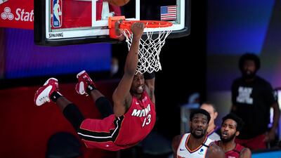 Miami Heat's Bam Adebayo dunks over Phoenix Suns' Deandre Ayton during the second half of an NBA basketball game in Lake Buena Vista, Florida. AP Photo