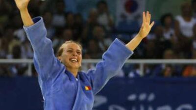 Alina Alexandra Dumitru of Romina reacts after defeating Yanet Bermoy of Cuba to win the gold medal competition of the women's judo extra lightweight division.