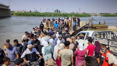 People in Deir Ezzor are packed on to a ferry to reach the other side of the city. Sana