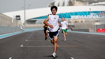 Abdulla Arjomand, 13, from the Universal American School, makes his way down the home straight to win the Under 14 race of the first leg of the regional Middle East South Asia Conference (MESAC) cross country meet at Yas Marina Circuit in Abu Dhabi on Friday.
