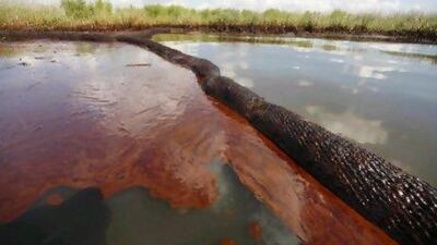 Oil from the Deepwater Horizon oil spill covers the water in Bay Jimmy, Louisiana. Gerald Herbert / AP Photo