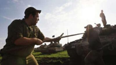 Israeli soldiers prepare their tanks as they take position on the Israeli-Gaza Strip border yesterday.