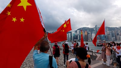 Supporters hold Chinese flags to celebrate the 24th anniversary of Hong Kong's return to Chinese rule in the former British colony last July. Reuters