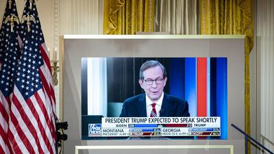 Chris Wallace, Fox News anchor, is displayed on a monitor during an election night party in the East Room of the White House in Washington. An aide for Mr Trump later claimed the network was trying to 'invalidate' the election. Bloomberg