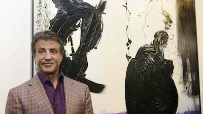 Actor and artist Sylvester Stallone poses in front of his painting, Family Ties, as he attends the opening of his show Real Love of paintings made from 1975-2015 and which are shown at the Galerie Contemporaine du Musee de Nice, in Nice, France, May 16, 2015. Reuters