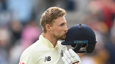 Joe Root celebrates reaching his century.