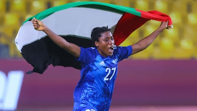 Abu Dhabi Country Club midfielder Rashida Ibrahim holds the UAE flag aloft after their victory over Al Nassr in the preliminary round of this season's tournament. AFP