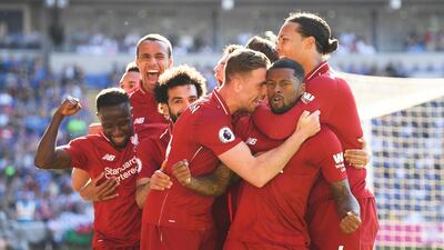 Georginio Wijnaldum is surrounded by teammates after scoring for Liverpool against Cardiff City on Sunday. Mike Hewitt / Getty Images