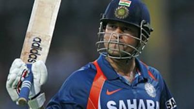 India's Sachin Tendulkar raises his bat to salute the crowd who applaud him on making his 44th one-day international hundred against Sri lanka today.