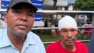 Newall Budhathok, left, with his brother Girilal Budhathoki, whose wife and child were killed in the fierce floods. Shazia Ahmed / The National