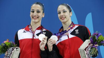 Eirini-Marina, left, and Anna-Maria Alexandri of Austria, celebrate their second place at the final of synchronised swimming, duets event at the 2015 European Games in Baku, Azerbaijan, Monday, June 15, 2015. (AP Photo/Dmitry Lovetsky)
