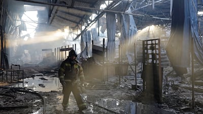 A firefighter works inside the burned-out Sigma shopping mall in Donetsk, a Russian-controlled city of Ukraine. Reuters