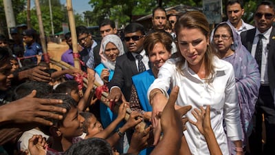 Queen Rania of Jordan shakes hands with Rohingya Muslim children, who have crossed over from Myanmar into Bangladesh, during her visit to Kutupalong refugee camp, Bangladesh. Dar Yasin / AP Photo