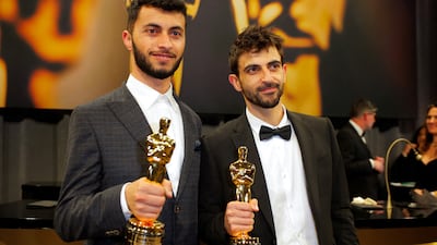 Basel Adra, left, and Yuval Abraham with their Oscars for Best Documentary Feature Film for No Other Land. Reuters