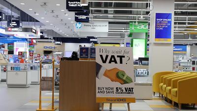 A VAT signboard at the entrance of Sharaf DG store at Ibn Battuta Mall in Dubai. Pawan Singh / The National