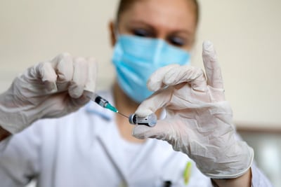 A nurse prepares a dose of Pfizer/BioNTech vaccine. EPA