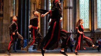 Performers from Alrowwad Dabka Dance group captured mid step.