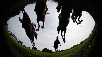 Runners and riders negotiate the first fence during the Maureen Sturt Ladies Day Novices’ Handicap Chase at Fontwell Park on August 13, 2015 in Fontwell, England. Mike Hewitt/Getty Images