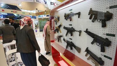 Above, firearms are on display at the Pakistan Ordnance Factories stands. Satish Kumar / The National