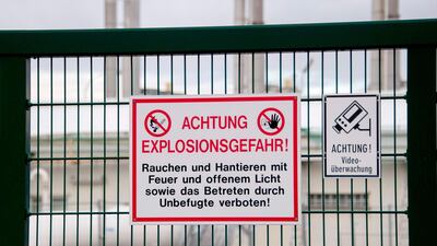 A shield reading "Attention — Danger of explosion" is pictured on a fence at the site of Austria's main gas pipeline hub at Baumgarten an der March, Eastern Vienna, after an explosion rocked the site on December 12, 2017. Joe Klamar / AFP